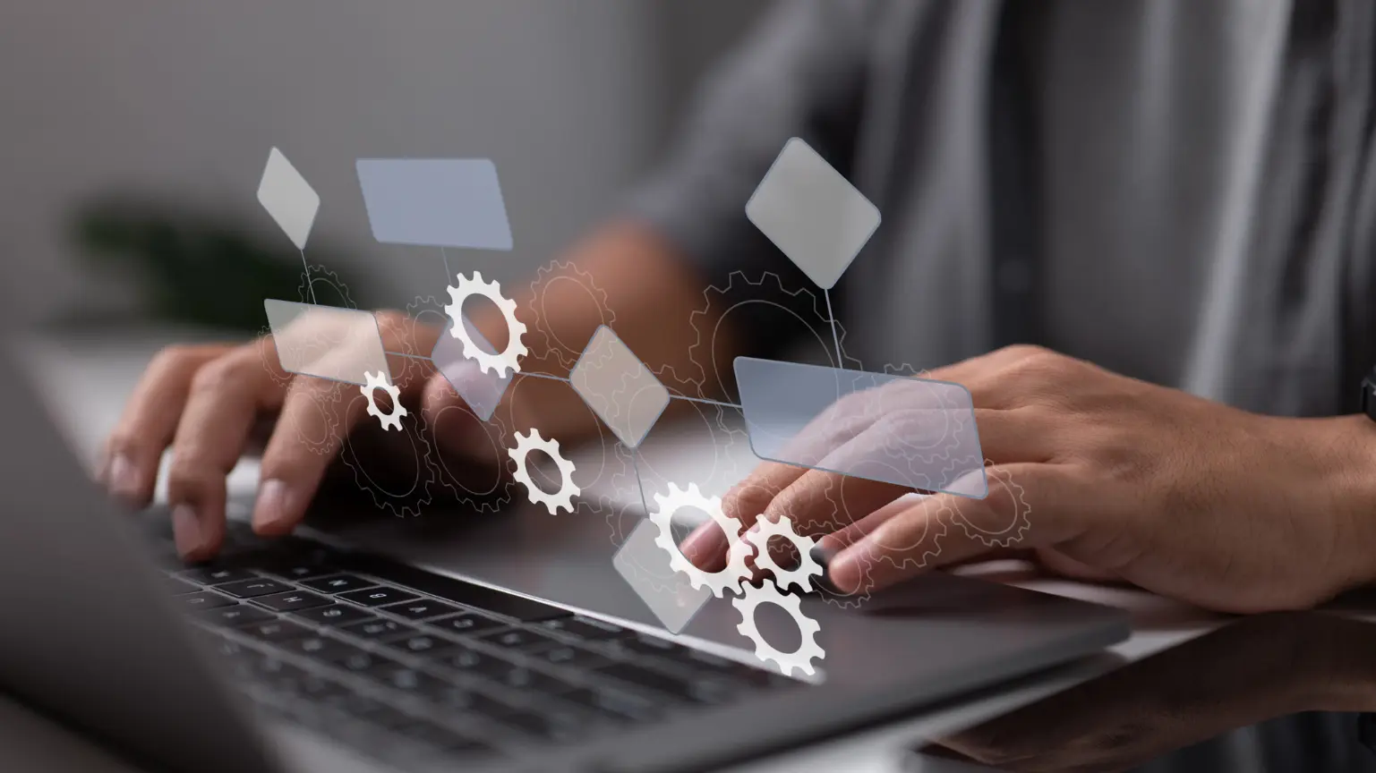 Person typing on a laptop with floating digital gears and flowchart symbols.